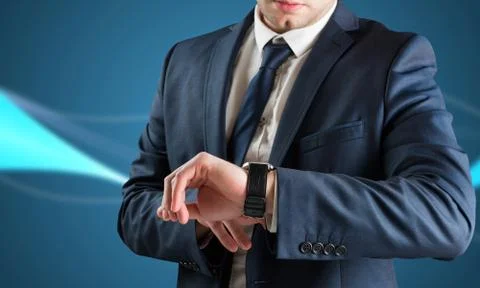 Composite image of businessman checking the time on watch Illustrazione stock