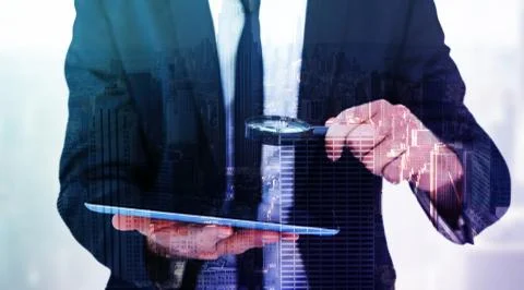 Composite image of businessman looking at his tablet through magnifying glass Ilustración de archivo