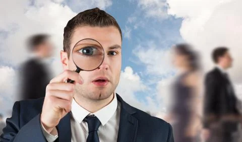 Composite image of businessman looking through magnifying glass 스톡 일러스트