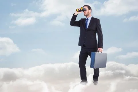 Composite image of businessman looking through binoculars holding briefcase Illustrazione stock