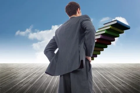 Composite image of businessman standing with hands on hips Illustrazione stock