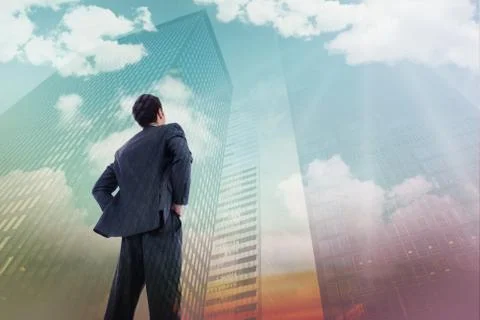 Composite image of businessman standing with hands on hips Ilustración de archivo