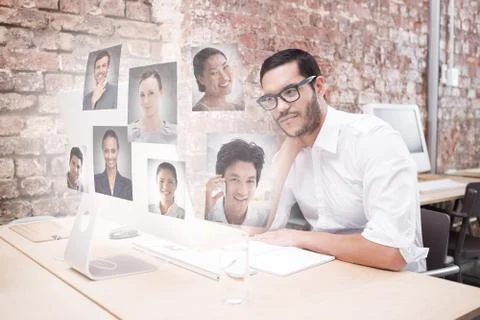 Composite image of businessman using computer at desk Illustrazione stock