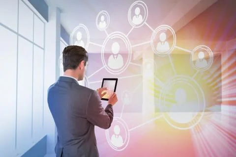 Composite image of businessman using digital tablet Foto stock