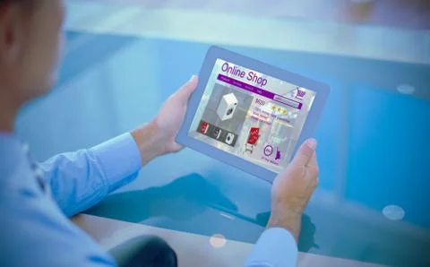 Composite image of businessman using his tablet Foto stock