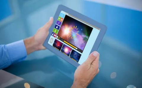Composite image of businessman using his tablet Foto stock