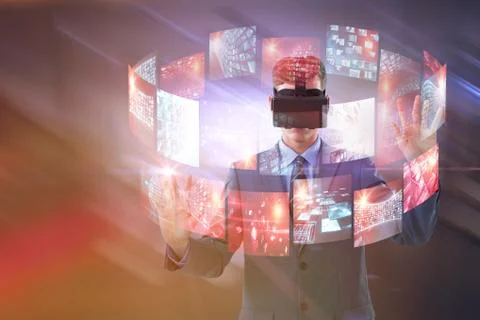 Composite image of businessman using virtual reality headset Stock Photos
