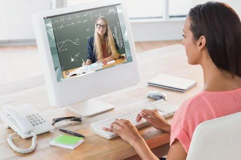 Composite image of businesswoman using computer at desk in creative office Stock Photos