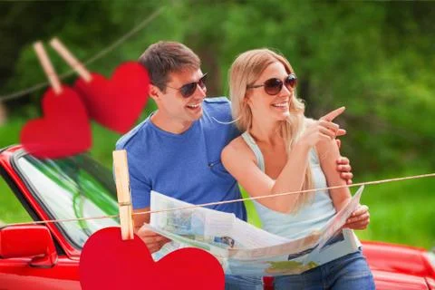Composite image of cheerful young couple reading map Ilustração Stock
