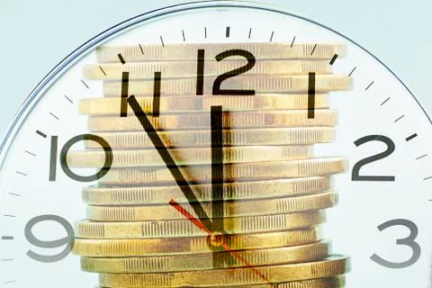 Composite image of a clock dial and gold coins Stock Photos
