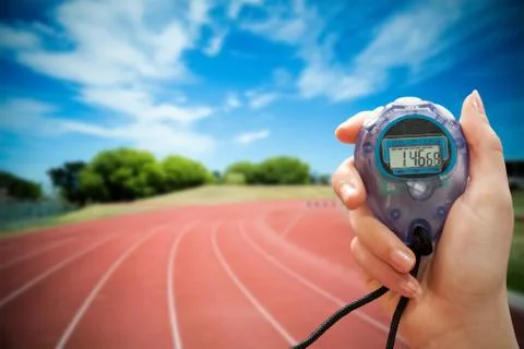 Composite image of close up of a hand holding a timer on a white background Stock Photos