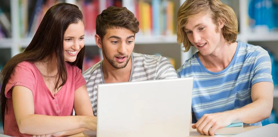 Composite image of college students using laptop in library 스톡 사진