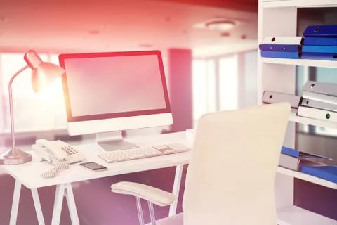 Composite image of computer with telephone and mobile phone at desk 스톡 사진