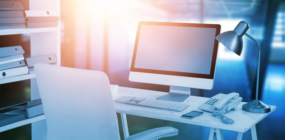 Composite image of computer with telephone and mobile phone at desk Foto stock
