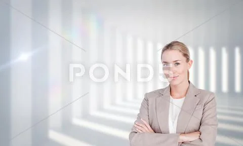 Composite image of confident female executive with folded arms Stock Photos