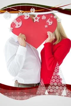 Composite image of couple embracing and holding heart over faces Ilustração Stock