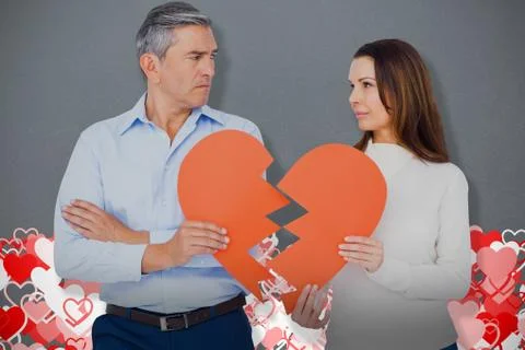 Composite image of couple holding broken heart shape paper Stock Photos