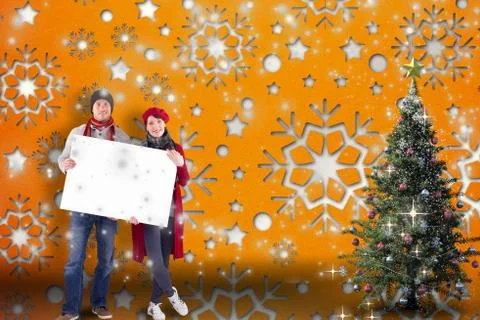 Composite image of couple holding a large sign Ilustración de archivo