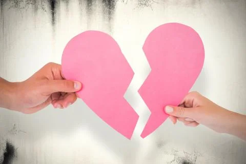 Composite image of couple holding two halves of broken heart Stock Photos