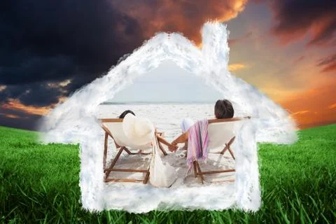 Composite image of couple looking ocean on their deck chairs Illustrazione stock