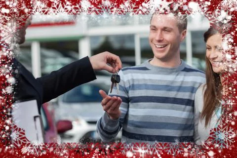 Composite image of couple receiving car keys by a dealer 스톡 일러스트