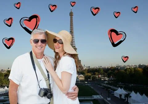 Composite image of couple standing against digitally generated eiffel tower and Fotos Stock