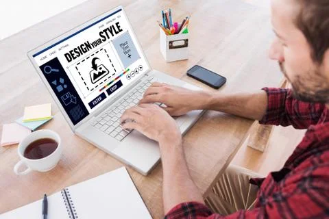 Composite image of creative businessman typing on laptop Stock Photos