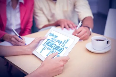 Composite image of creative team using tablet pc Illustrazione stock