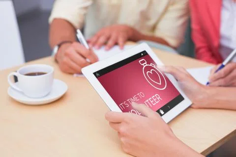Composite image of creative team using tablet pc Stock Photos