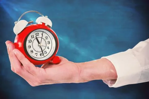 Composite image of cropped hand holding alarm clock Stock Photos