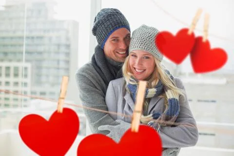 Composite image of cute couple in warm clothing smiling at camera Stock Illustration