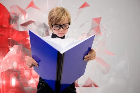 Composite image of cute pupil reading 스톡 사진
