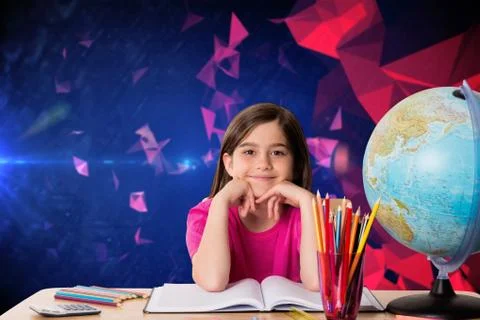 Composite image of cute pupil working at her desk Stock Photos