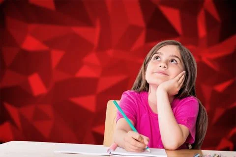 Composite image of cute pupil working at her desk Stock Photos