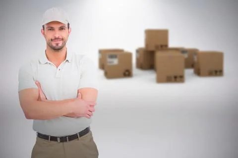 Composite image of delivery man standing arms crossed Fotos de archivo