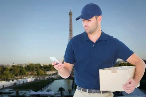 Composite image of delivery man using mobile phone while holding package Foto stock