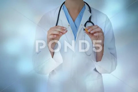 Composite image of doctor holding broken cigarette as incentive to quit Stock Photos