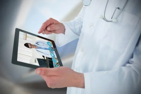 Composite image of doctor using digital tablet Stock Photos