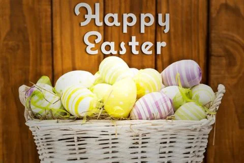 Composite image of easter eggs in basket Illustrazione stock