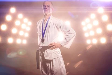 Composite image of fighter posing with medal around his neck Stock Photos