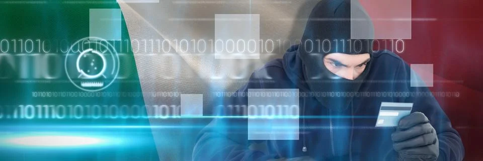 Composite image of focused burglar using computer and debit card Foto stock