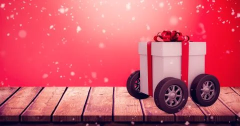 Composite image of gift box with red ribbon on wheels Stock Illustration