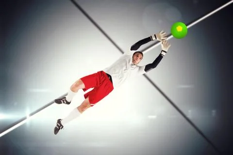 Composite image of goalkeeper in white jumping up Illustrazione stock