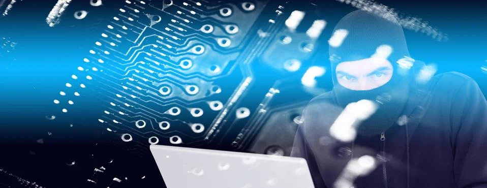 Composite image of hacker in balaclava hacking a laptop 写真素材