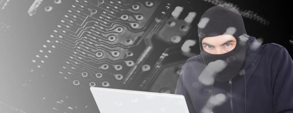 Composite image of hacker in balaclava hacking a laptop Stock Photos