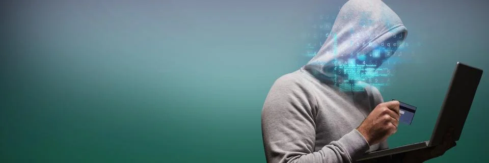 Composite image of hacker using laptop while holding credit card 스톡 사진
