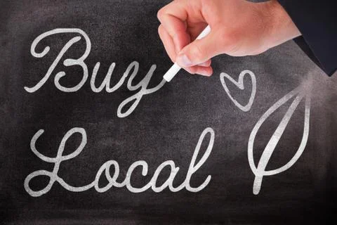 Composite image of hand holding a chalk and writing something Foto stock