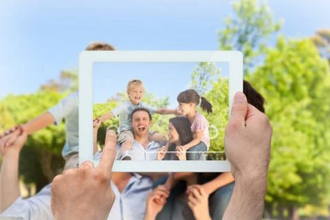 Composite image of hand holding tablet pc Foto stock