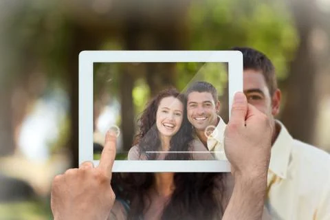 Composite image of hand holding tablet pc Foto stock