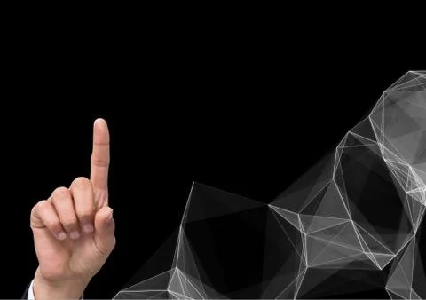 Composite image of Hand Pointing against graphic Polygons on dark background Fotos de archivo